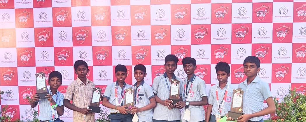 Students holding trophies at competition